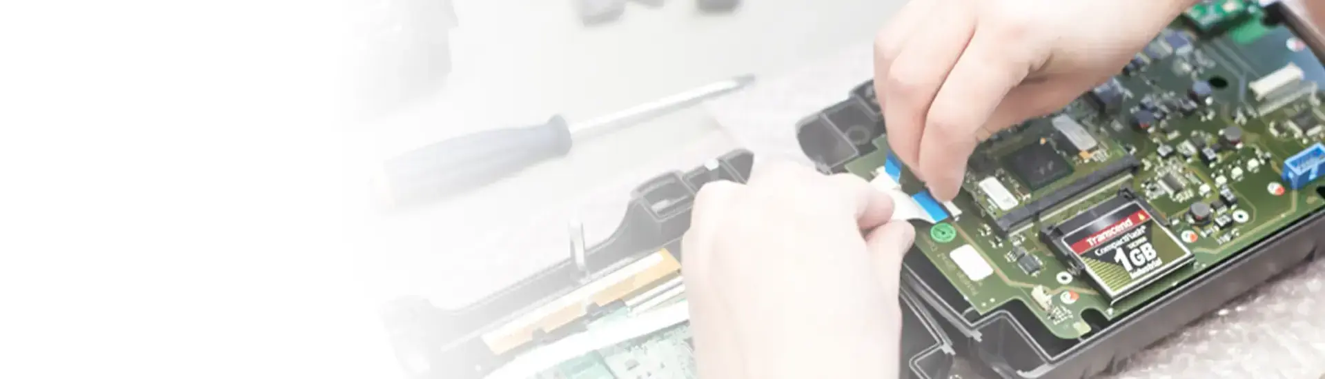 Closeup of tech connecting cables to circuit board