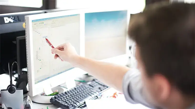 Worker analyzing vibration measurements from VIBXPERT II on computer monitor
